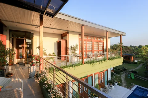 Upper terrace in evening light looking down toward the pool and tropical garden