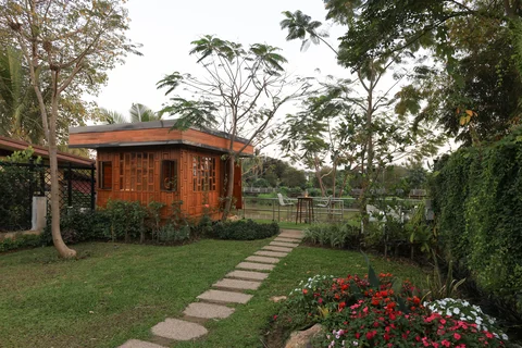 Charming garden sala pavilion with stepping stone path and tropical flower garden