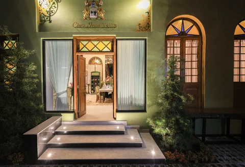 Villa entrance at night - lit steps leading to the Chez Jean Villa door flanked by tropical plants