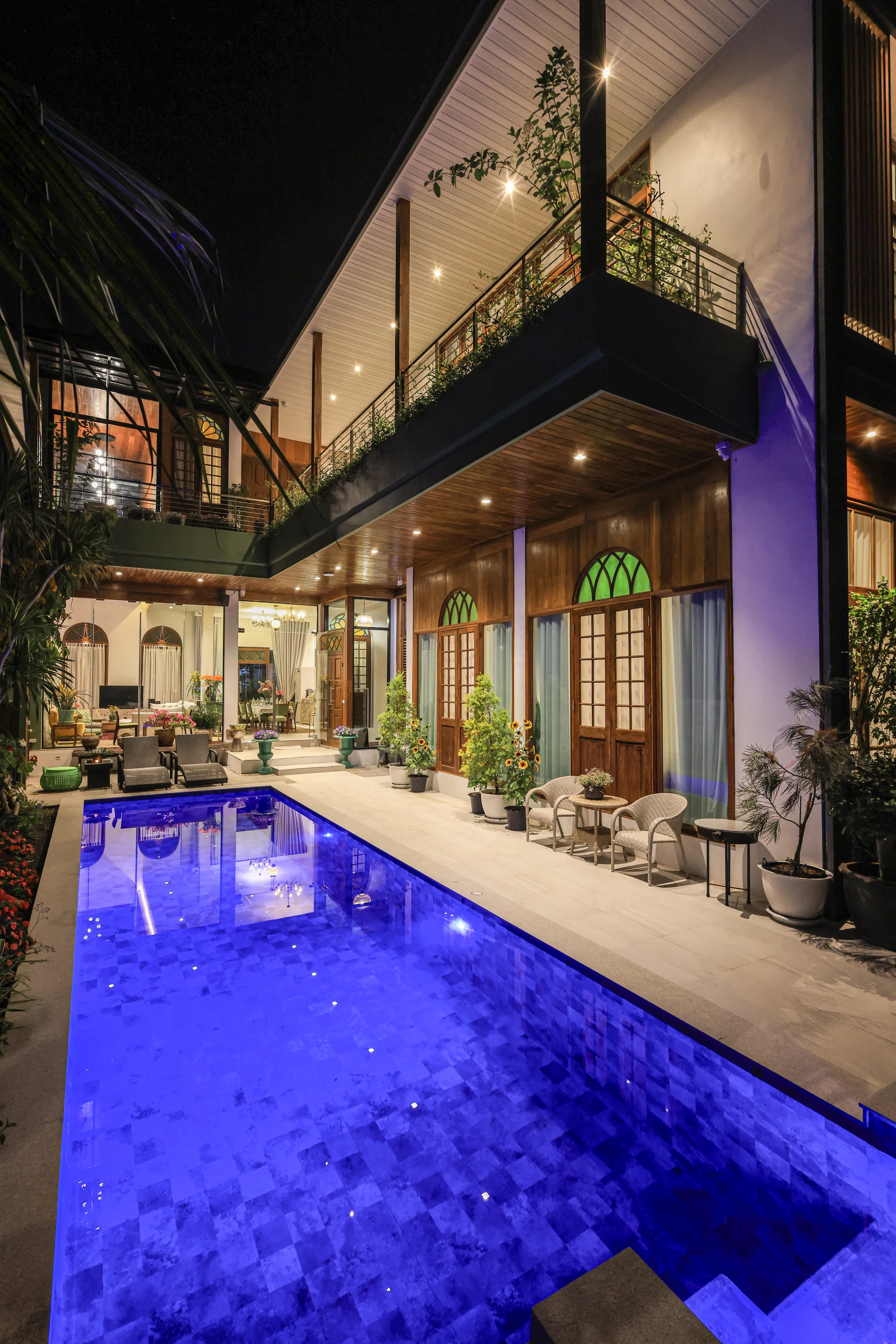 Luxury swimming pool surrounded by family, sun loungers